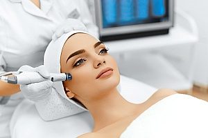 a woman at a medical spa receiving hydro skincare treatments in order to radiate her skin and remove facial lines to look much younger than before