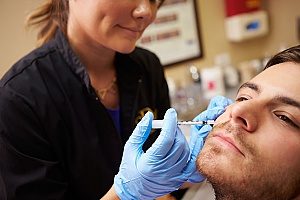 a man receiving botox treatment due to facial lines and migraines and excessive underarm sweating