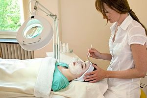 skincare professional performing a sensi peel on a client 