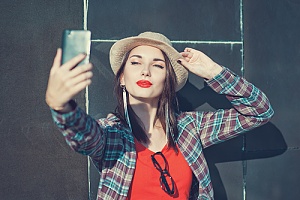 woman taking picture of herself after microneedling