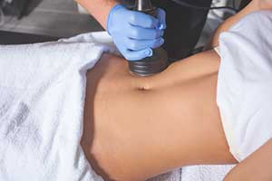 man performing a venus legacy treatment on womens abdomen