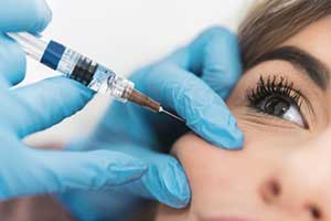 woman receving dose of radiesse filler treatment