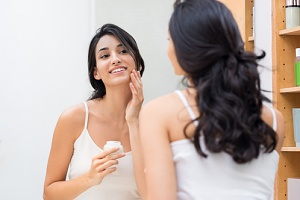 person using botox in a bottle after reading the pros and cons