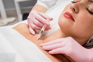 someone receiving home microneedling treatements