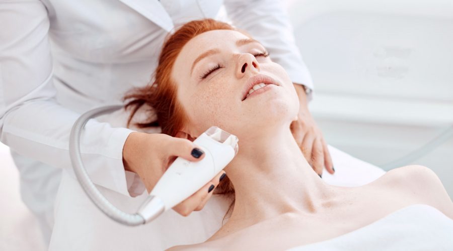 a woman receiving Venus Legacy treatment on her face and neck
