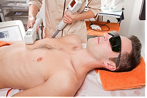 Man receiving laser hair removal treatment