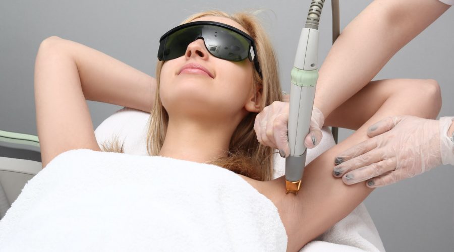woman receiving laser hair removal in the armpits