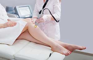 woman receiving laser hair removal on her legs