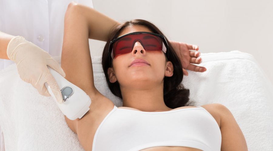 Woman getting laser hair removal in armpit
