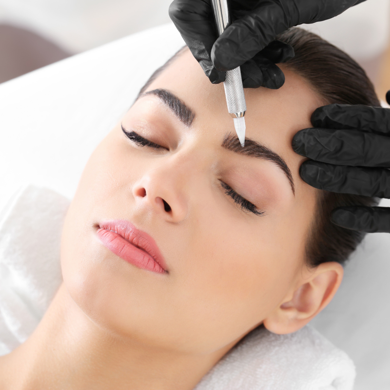 Woman receiving eyebrow tinting and shaping services